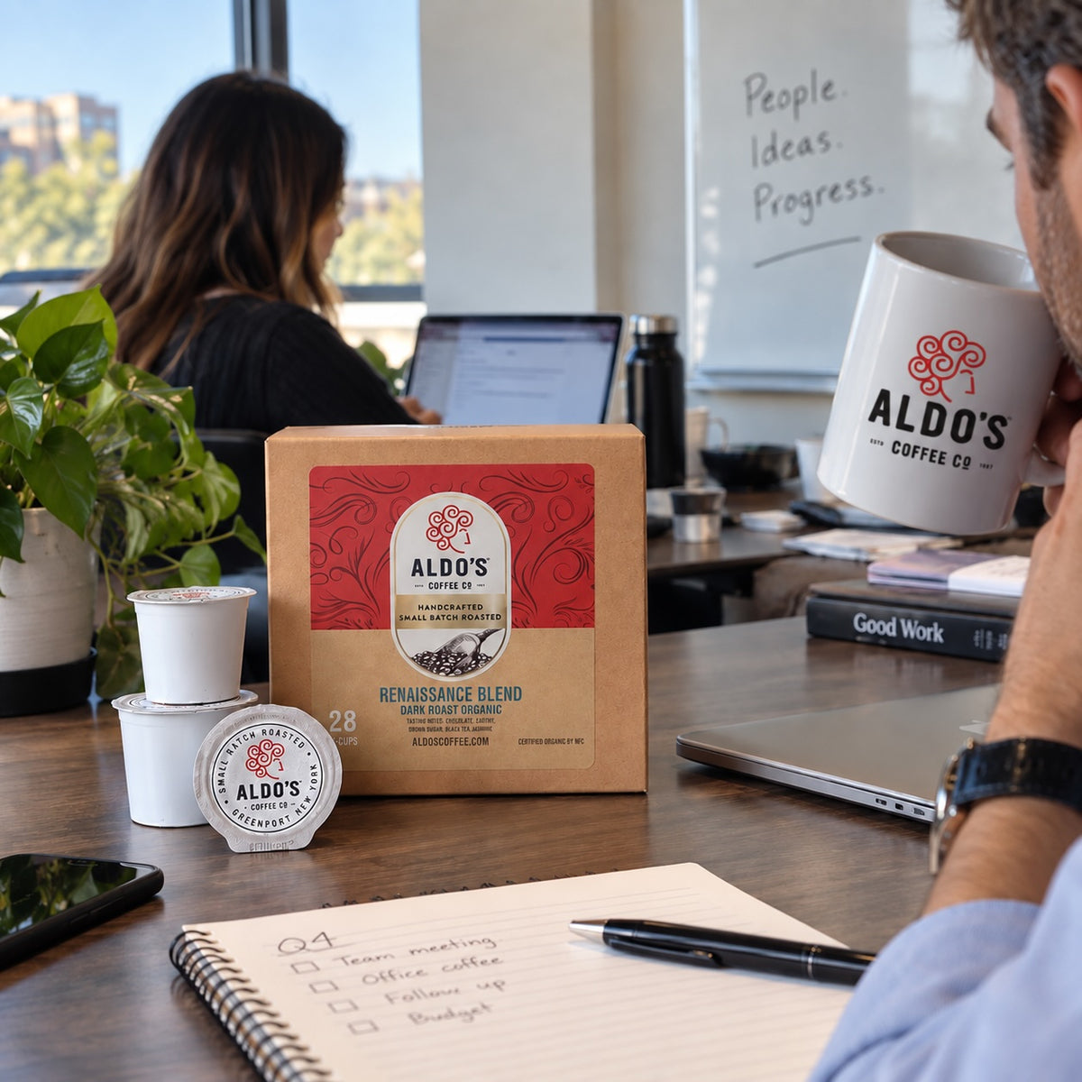 Aldo's single-serve pods beside a single-serve brewer in an office